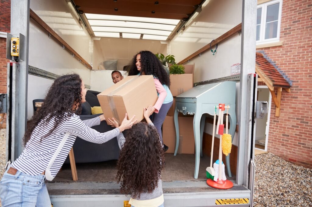 a group of people holding a box in a truck