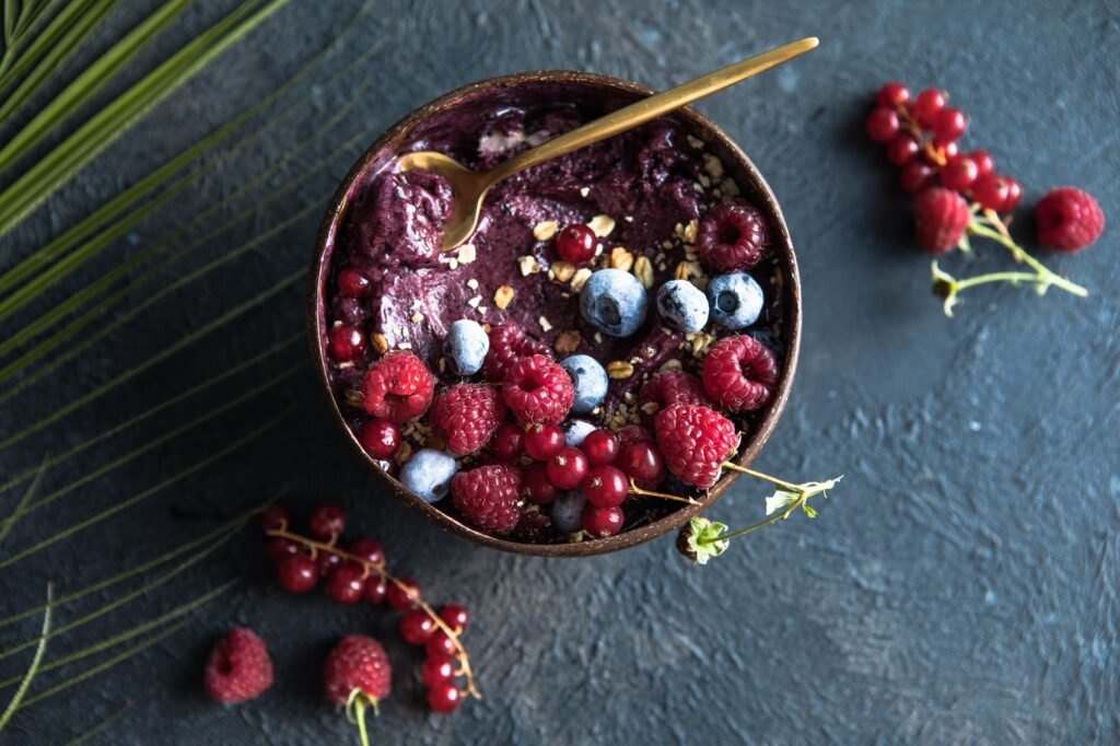 a bowl of fruit and oatmeal with a spoon